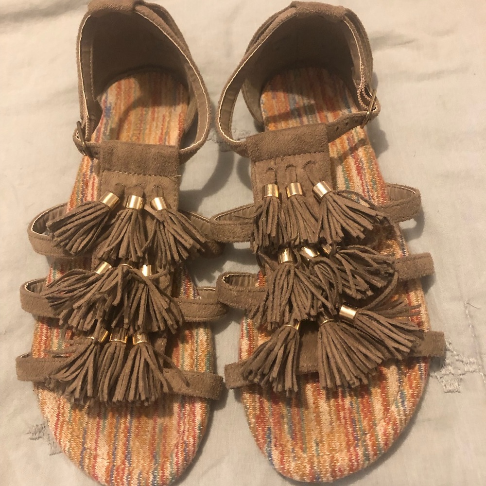 Brown and gold tassel sandals.